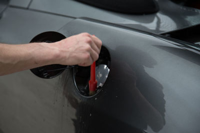 Close-up of hand holding car