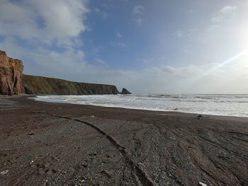 Scenic view of beach against sky