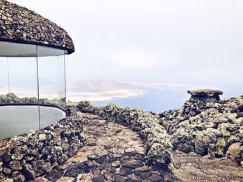 Scenic view of sea and mountains against sky