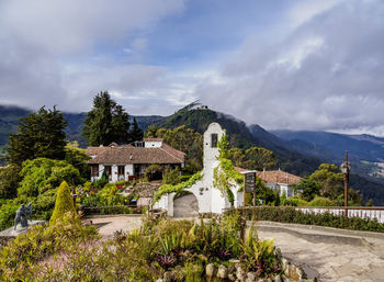 Panoramic view of buildings and mountains against sky