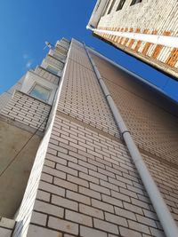 Low angle view of skyscraper against clear blue sky