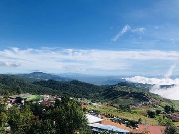 High angle view of houses and trees against sky