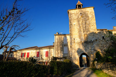 Low angle view of historic building against blue sky