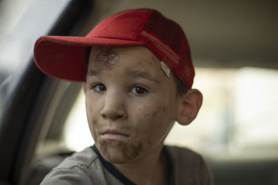 Close-up portrait of boy wearing hat