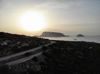 Scenic view of land against sky during sunset