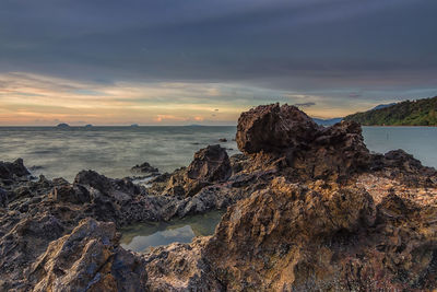 Beautiful landscape shot with a big rock against the dark sky.