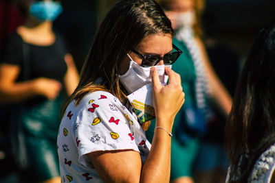 Portrait of woman wearing sunglasses standing outdoors