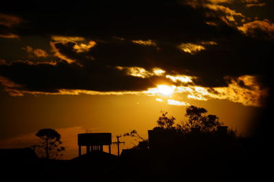 Silhouette trees against sky during sunset