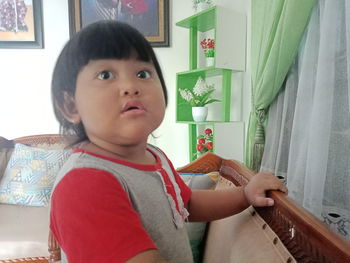 Boy looking away while sitting at home