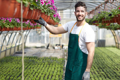 Full length of man standing in greenhouse