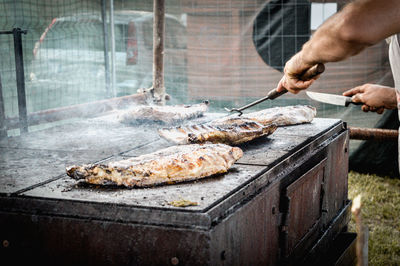 Man preparing food on barbecue grill