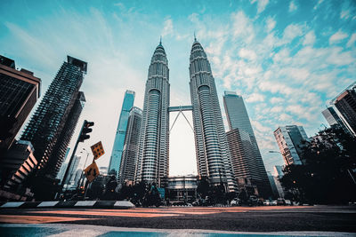 Low angle view of buildings against cloudy sky