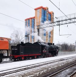 Train on railroad tracks against sky