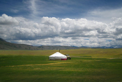 Built structure on field against sky