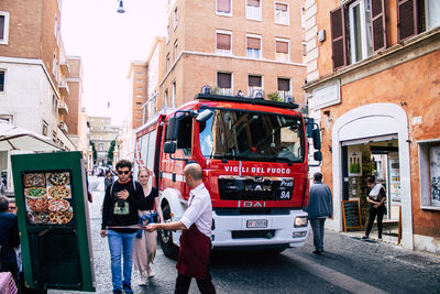 People standing on street in city