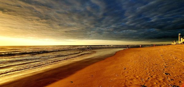 Scenic view of beach against sky during sunset