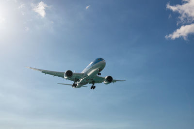 Low angle view of airplane flying against sky