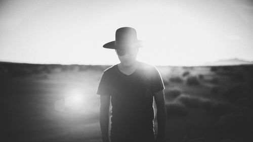 Rear view of silhouette man standing at music concert