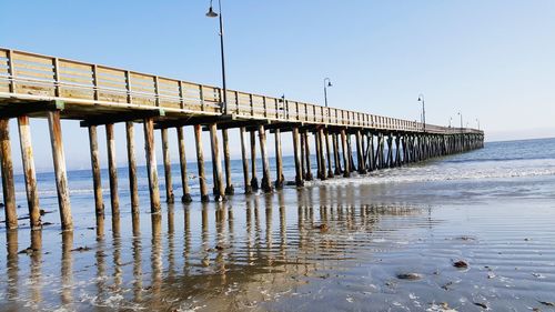 Pier on sea against clear sky