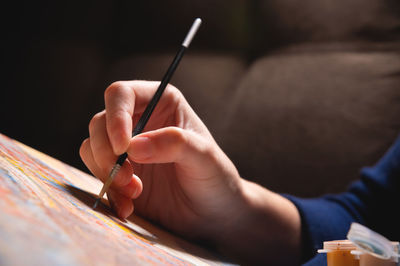 Cropped hand of woman drawing