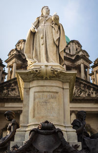 Low angle view of statue against sky