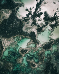 High angle aerial view of sea and volcanic rock 