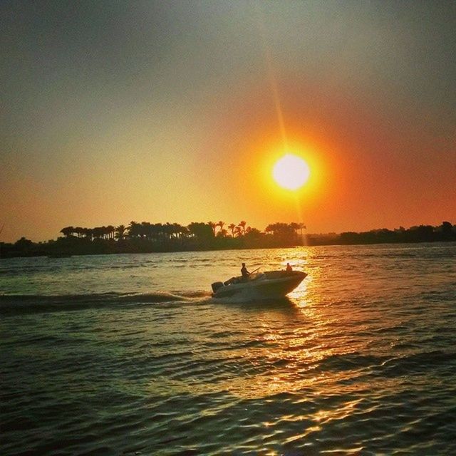 sunset, nautical vessel, transportation, water, mode of transport, boat, sun, orange color, sea, waterfront, scenics, silhouette, beauty in nature, tranquil scene, sailing, tranquility, nature, sky, sunlight, idyllic