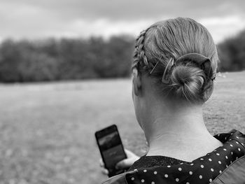 Rear view of woman photographing