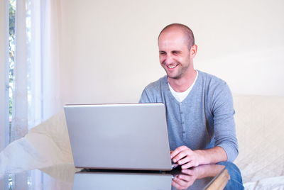 Portrait of smiling man using mobile phone