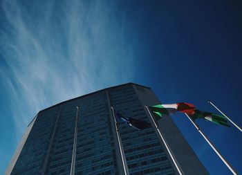 Low angle view of flag on building against sky