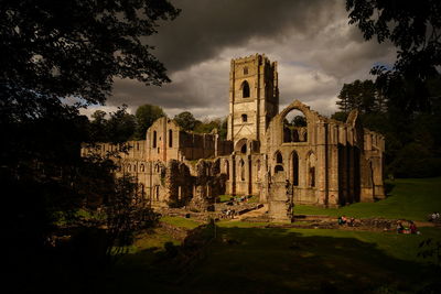 Old ruins of temple against cloudy sky