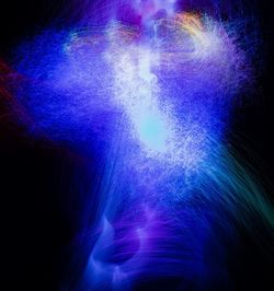 Low angle view of firework display over black background