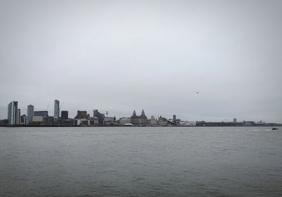 Scenic view of sea and buildings against sky