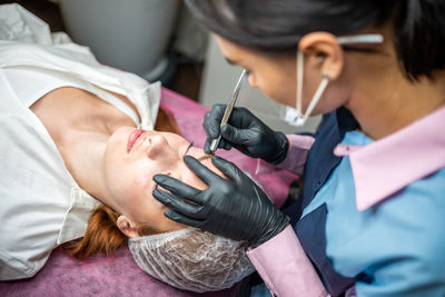 Midsection of doctor examining patient at clinic