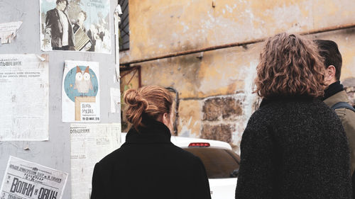 Rear view of woman looking at camera