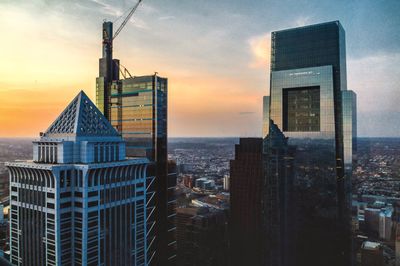 Buildings in city during sunset