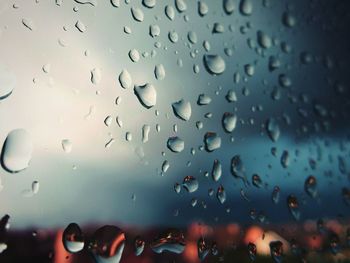 Close-up of wet glass window during rainy season