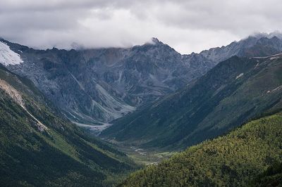 Scenic view of mountains against cloudy sky