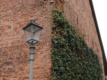 Low angle view of street light against building