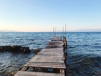 Pier over sea against clear sky
