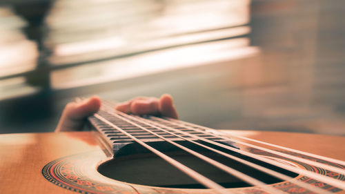 Cropped image of hand holding guitar