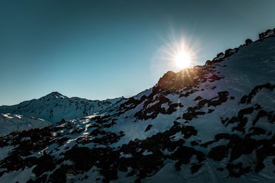 Scenic view of snowcapped mountains against clear sky