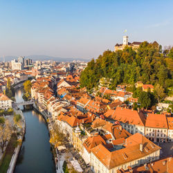 High angle view of river amidst buildings against clear sky