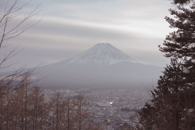 Scenic view of snowcapped mountain against cloudy sky