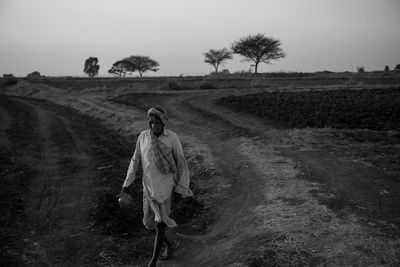 Full length of woman standing on field