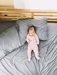 High angle view of cute baby on bed at home