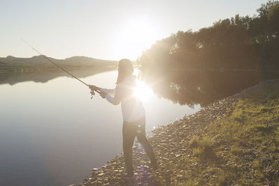 Person fishing at river