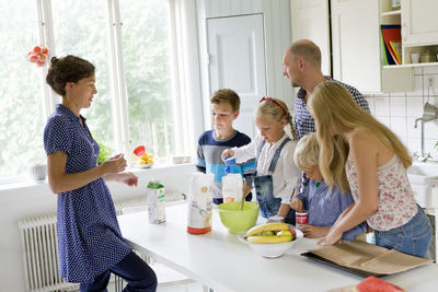 Family preparing food in kitchen