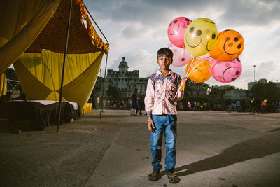 Full length of a man holding balloons