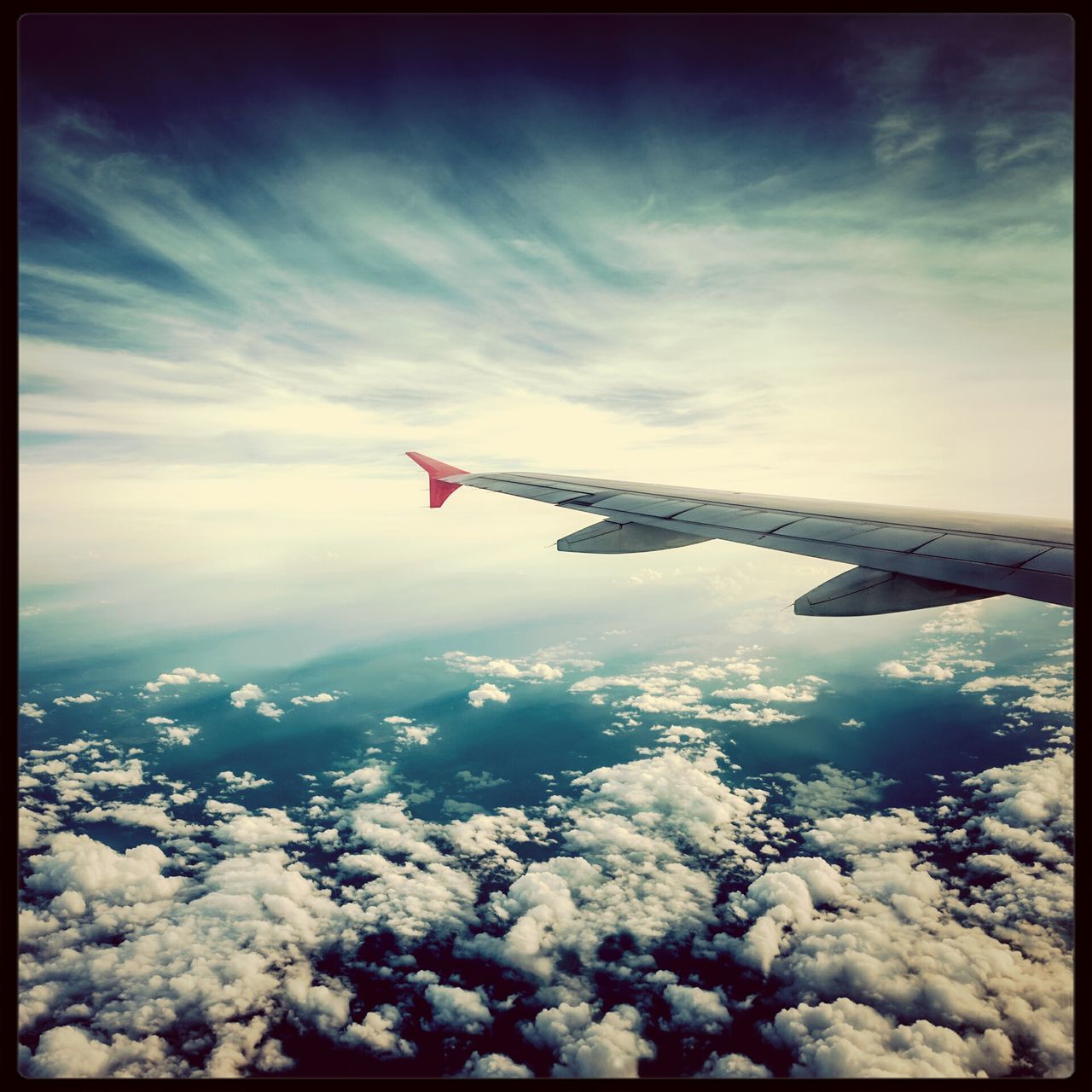 airplane, aircraft wing, flying, transportation, air vehicle, mode of transport, sky, aerial view, cloud - sky, part of, cropped, travel, mid-air, on the move, journey, scenics, cloud, beauty in nature, public transportation, nature